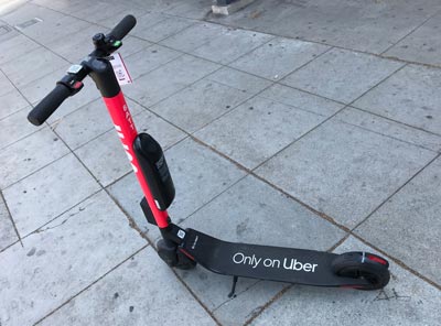 Image of an Uber jump scooter on a sidewalk