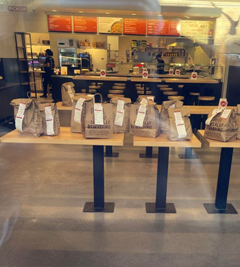A table with several delivery bags sitting out