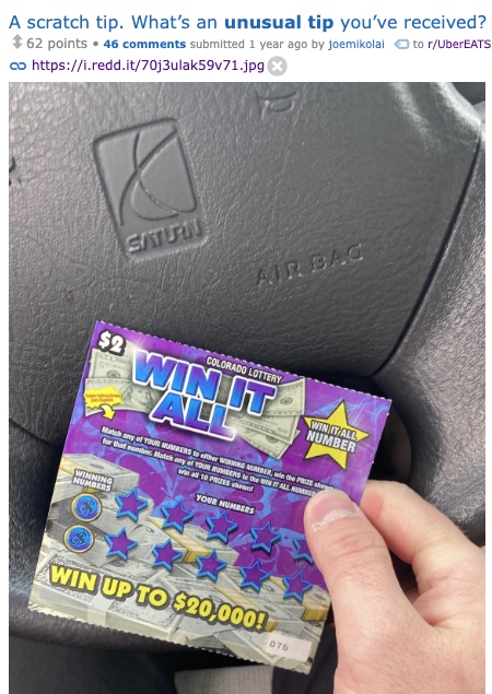 a hand holding a scratch off lotto ticket
